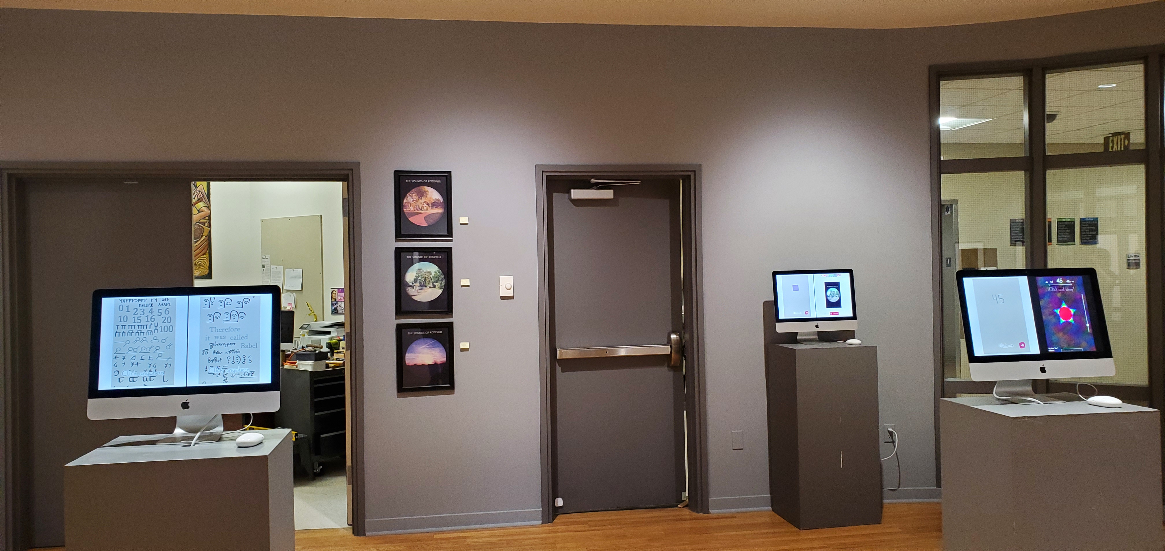 The Ridley art gallery, with my projects displayed on monitors sitting on pedastals, and The Sounds of Roseville prints mounted on the wall.